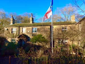 Bleachmill house with St George’s and Yorkshire flags flying